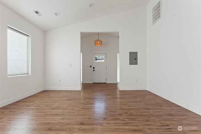 entryway featuring lofted ceiling, hardwood / wood-style floors, and electric panel