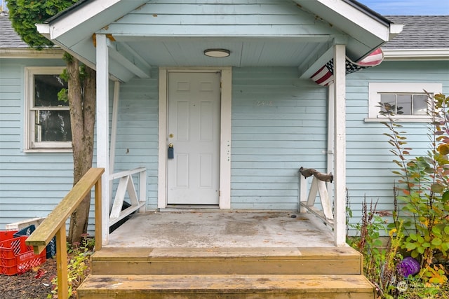 view of exterior entry with a porch