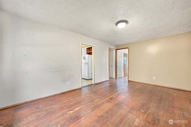 spare room featuring a textured ceiling and hardwood / wood-style flooring