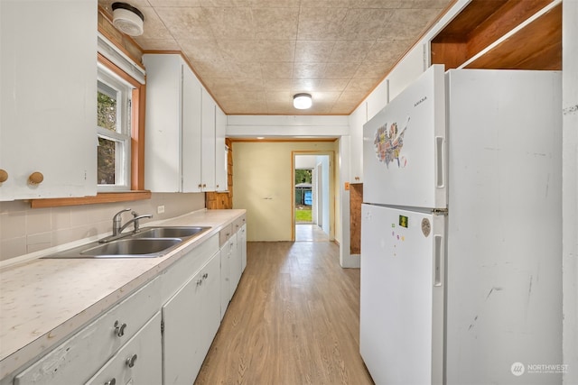 kitchen with white cabinetry, a healthy amount of sunlight, and sink