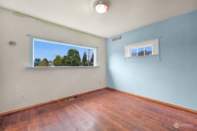 empty room with hardwood / wood-style flooring