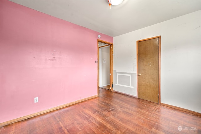 empty room with wood-type flooring