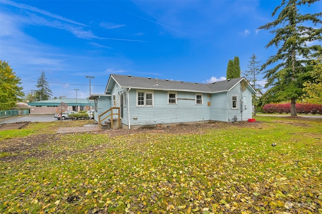 back of house featuring a yard