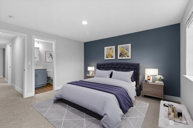 carpeted bedroom featuring connected bathroom