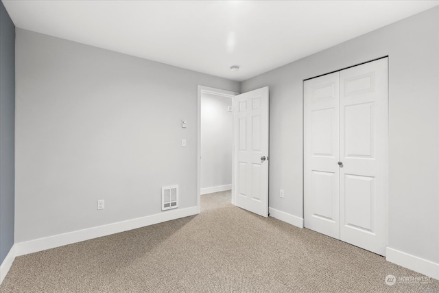 unfurnished bedroom with carpet flooring and a closet