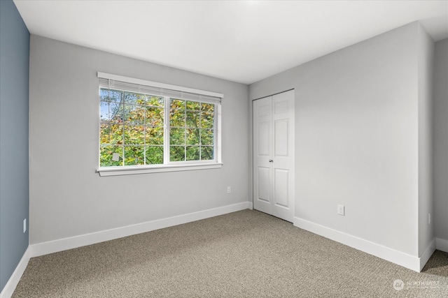 unfurnished bedroom with carpet and a closet