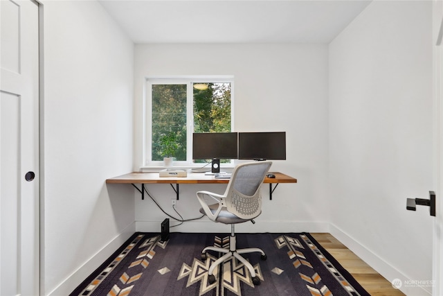 home office with hardwood / wood-style flooring