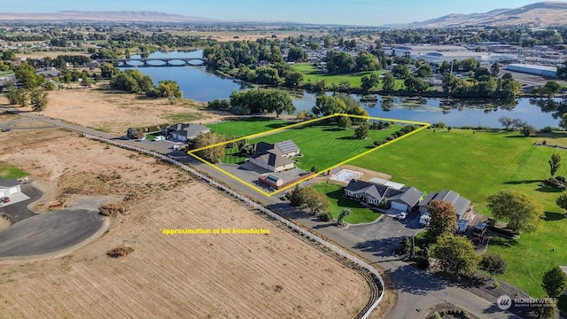 birds eye view of property featuring a water and mountain view