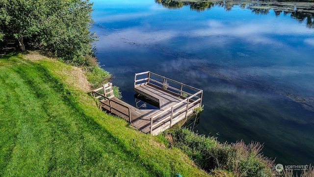 dock area featuring a water view and a lawn