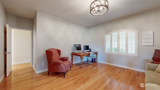 office featuring an inviting chandelier and light wood-type flooring