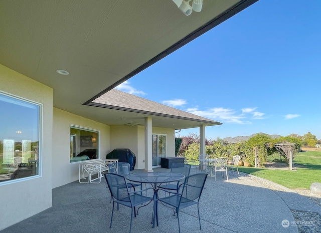 view of patio / terrace with a mountain view, ceiling fan, and grilling area