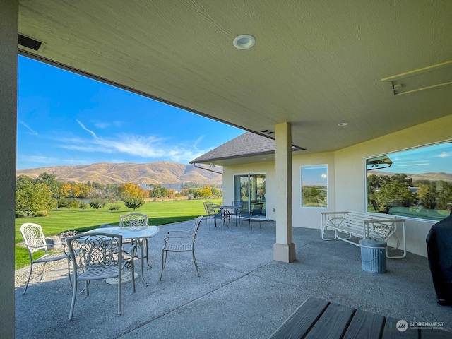 view of patio / terrace with a mountain view