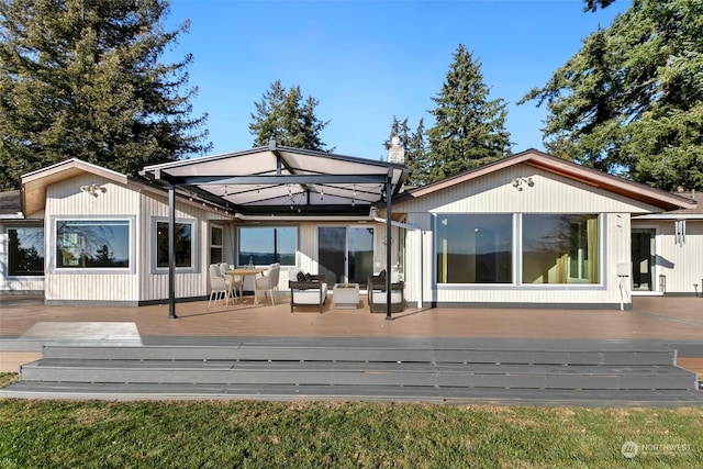 back of house with an outdoor living space and a wooden deck