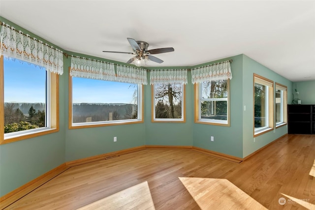 interior space with ceiling fan and light wood-type flooring