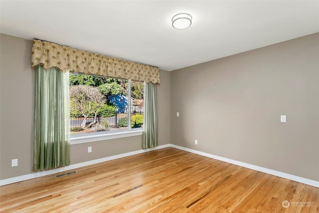 empty room with hardwood / wood-style flooring