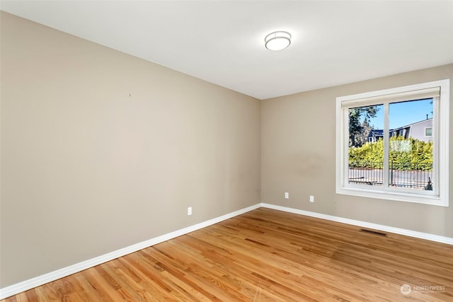 unfurnished room featuring hardwood / wood-style flooring