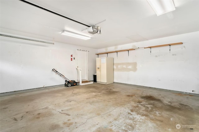 garage with a garage door opener and white fridge with ice dispenser