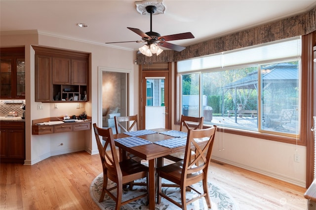 dining room featuring ceiling fan, ornamental molding, and light hardwood / wood-style floors