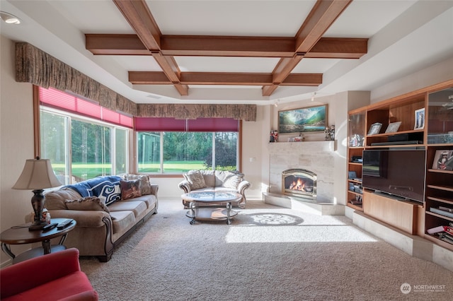 living room with beam ceiling, a healthy amount of sunlight, coffered ceiling, and a fireplace