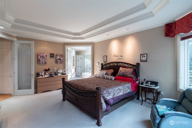 carpeted bedroom featuring crown molding, a raised ceiling, and multiple windows