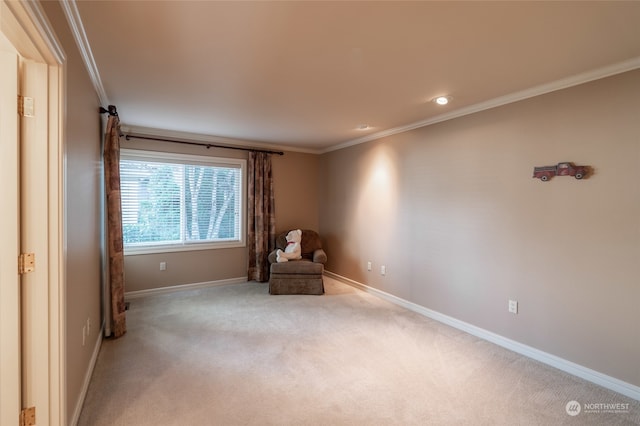 unfurnished room with ornamental molding and light colored carpet