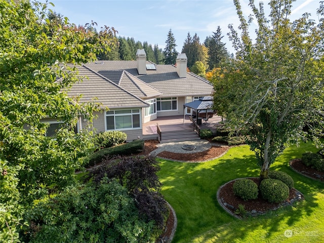 view of front of house featuring a gazebo, a deck, and a front lawn