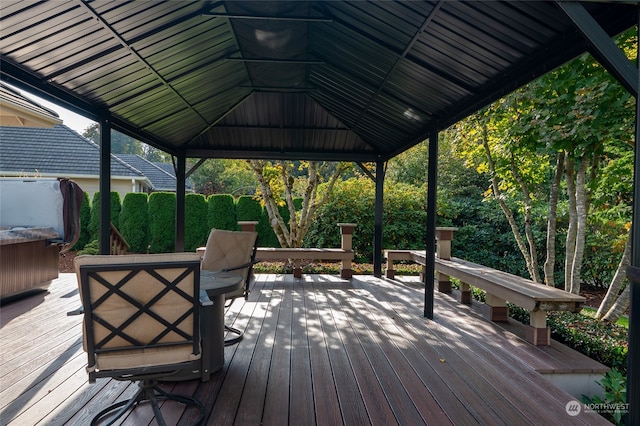 wooden terrace with a hot tub and a gazebo