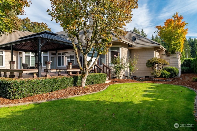 view of front of house with a front yard and a deck