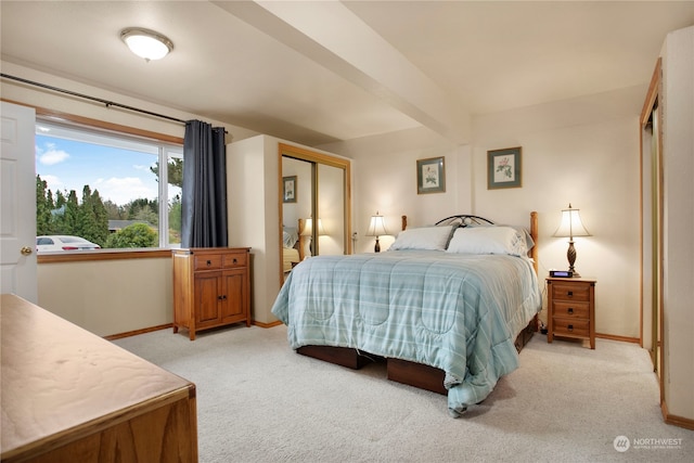 bedroom with beamed ceiling and light carpet