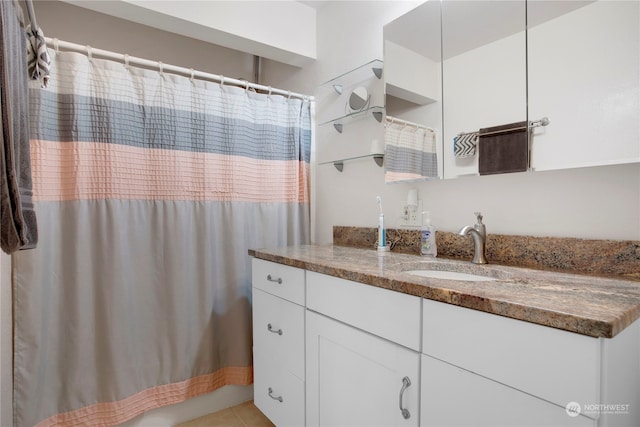 bathroom featuring vanity, tile patterned floors, and a shower with curtain