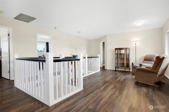 sitting room with dark wood-type flooring