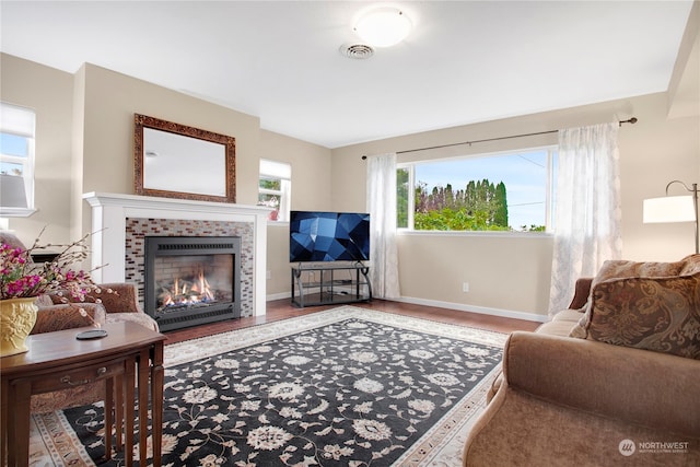 living room with hardwood / wood-style floors and a tile fireplace