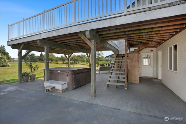 view of patio featuring a hot tub and a deck