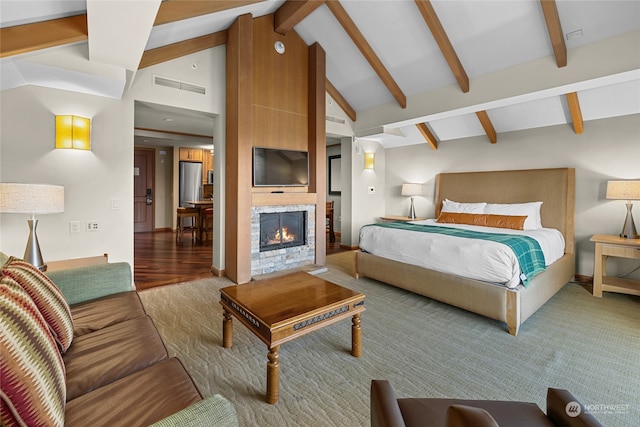 bedroom featuring stainless steel refrigerator, vaulted ceiling with beams, and hardwood / wood-style floors