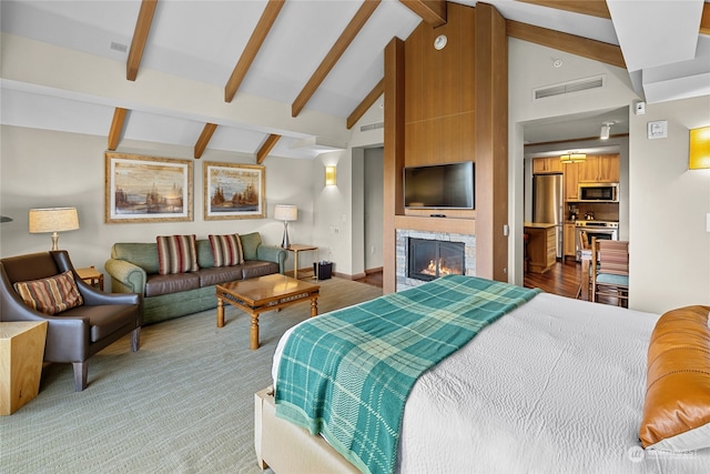 bedroom with stainless steel refrigerator and vaulted ceiling with beams