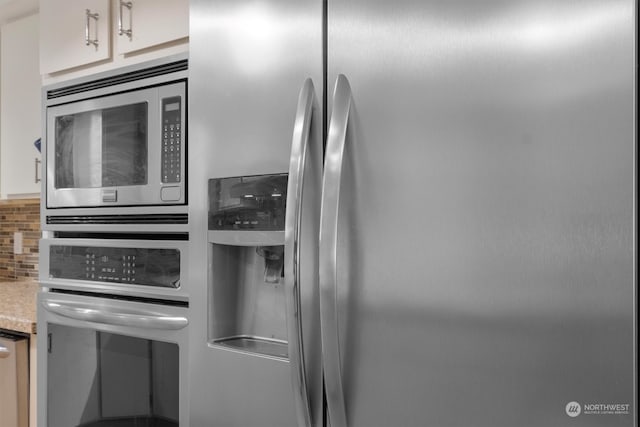 kitchen featuring stainless steel appliances and tasteful backsplash