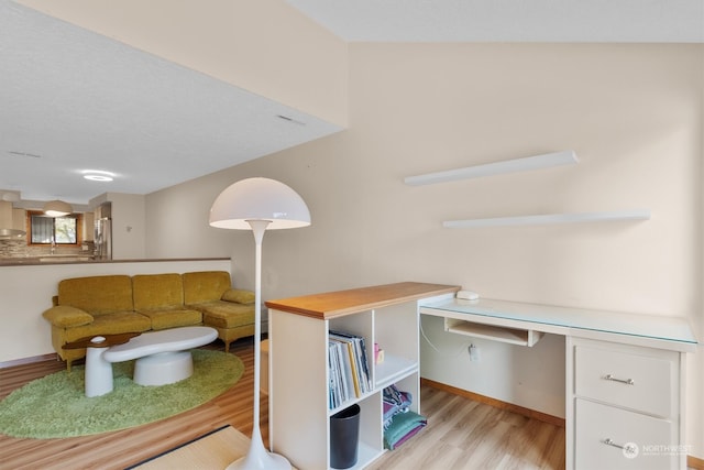 living room with built in desk and light hardwood / wood-style floors