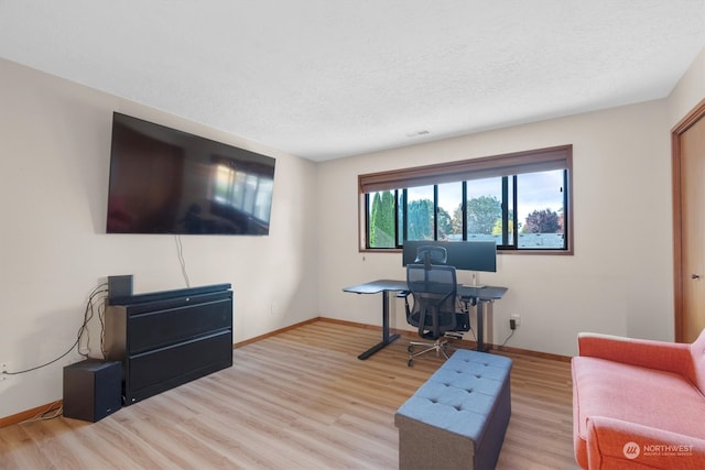 living room with light hardwood / wood-style flooring and a textured ceiling