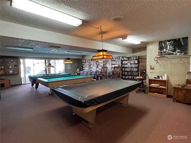 game room with a textured ceiling, carpet floors, and pool table