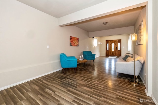 unfurnished room featuring beamed ceiling and dark wood-type flooring