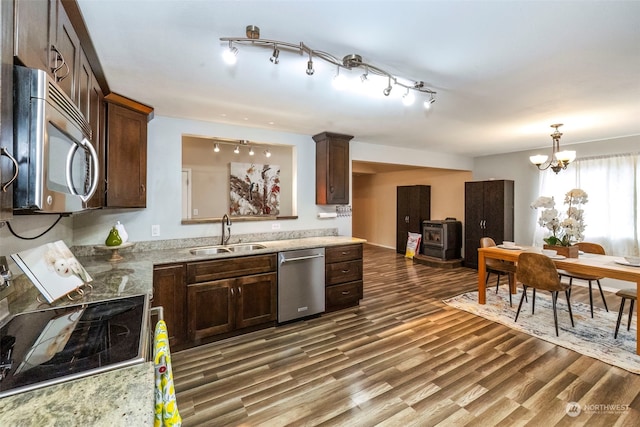 kitchen featuring sink, dark brown cabinets, a chandelier, and appliances with stainless steel finishes