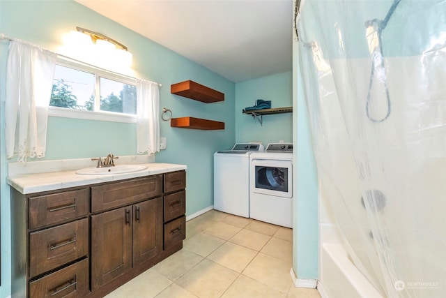 bathroom with tile patterned floors, vanity, shower / tub combo, and washer and dryer