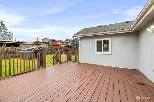 wooden terrace with a lawn