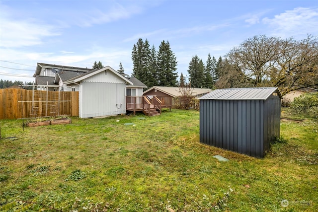 view of yard with a storage shed and a deck