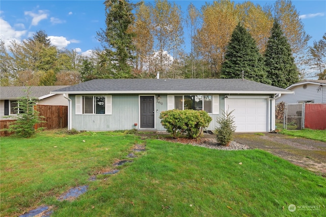 single story home with a front yard and a garage