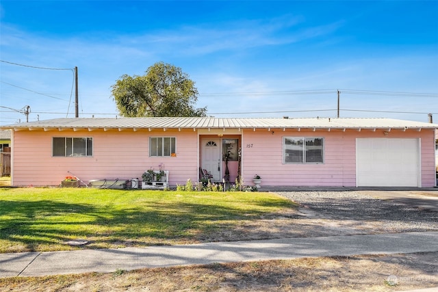 ranch-style house with a garage and a front lawn