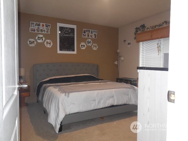 bedroom featuring light colored carpet