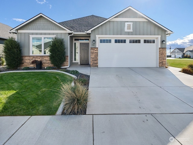 view of front of home with a garage and a front lawn