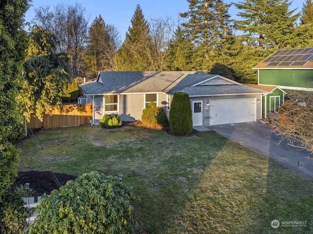 single story home with a garage, a front lawn, and solar panels