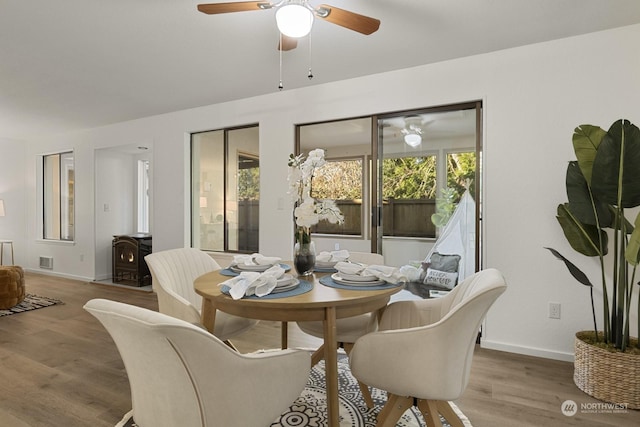 dining area featuring ceiling fan and light wood-type flooring